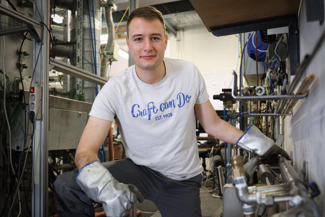 Student in front of a technical plant